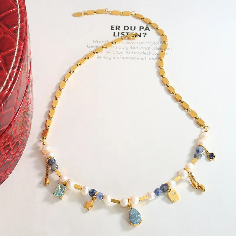 JINDOOR Elegant Golden Necklace with Freshwater Pearls, Blue Stones & Celestial Charms – Interwoven Jewelry for Women