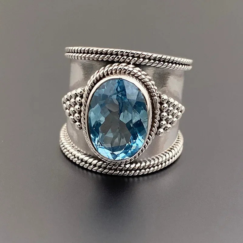 A woman's blue topaz gold-plated blue gemstone clawless and shiny ring