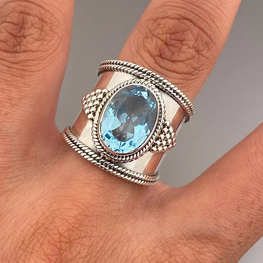 A woman's blue topaz gold-plated blue gemstone clawless and shiny ring