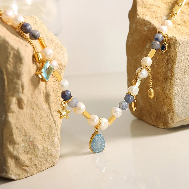 JINDOOR Elegant Golden Necklace with Freshwater Pearls, Blue Stones & Celestial Charms – Interwoven Jewelry for Women